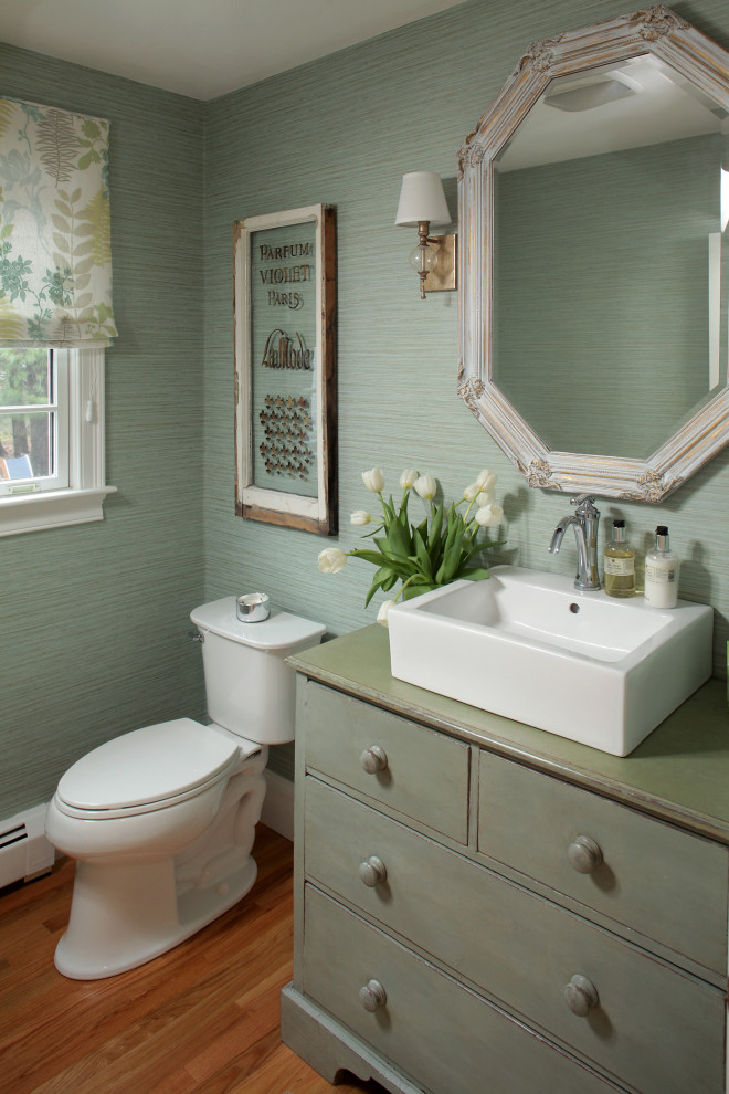 Photo of a medium sized classic cloakroom in Boston with freestanding cabinets, green cabinets, green walls, medium hardwood flooring, a vessel sink, brown floors, green worktops and a built in vanity unit.