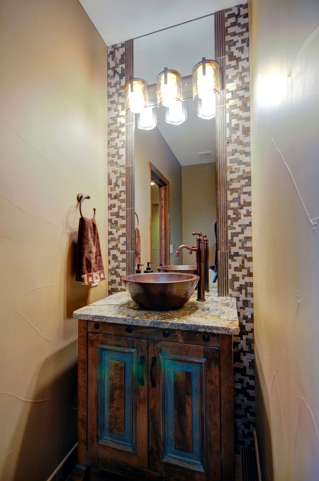 Inspiration for a small transitional powder room remodel in Denver with a vessel sink, furniture-like cabinets, granite countertops, beige walls and distressed cabinets