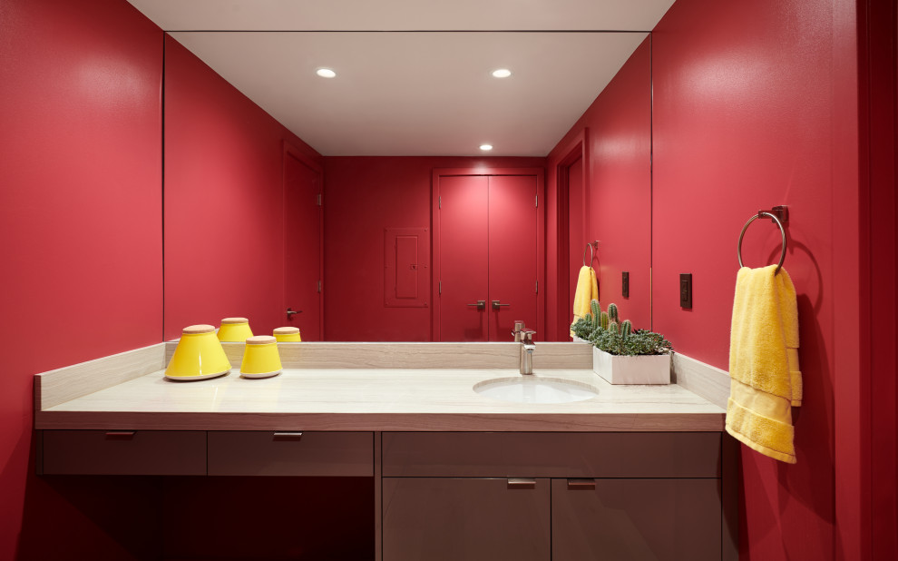 Photo of a large contemporary cloakroom in San Francisco with flat-panel cabinets, brown cabinets, pink walls, marble flooring, a submerged sink, marble worktops, beige floors, beige worktops and a floating vanity unit.