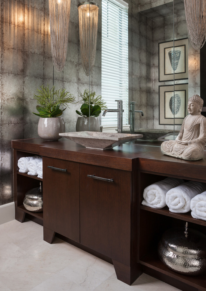 World-inspired cloakroom in Miami with flat-panel cabinets, dark wood cabinets, grey walls, a vessel sink, wooden worktops, beige floors and brown worktops.