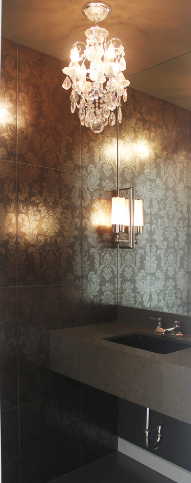 Immagine di un bagno di servizio minimalista con lavabo sottopiano, top in superficie solida, piastrelle grigie, piastrelle in gres porcellanato e pavimento con piastrelle in ceramica