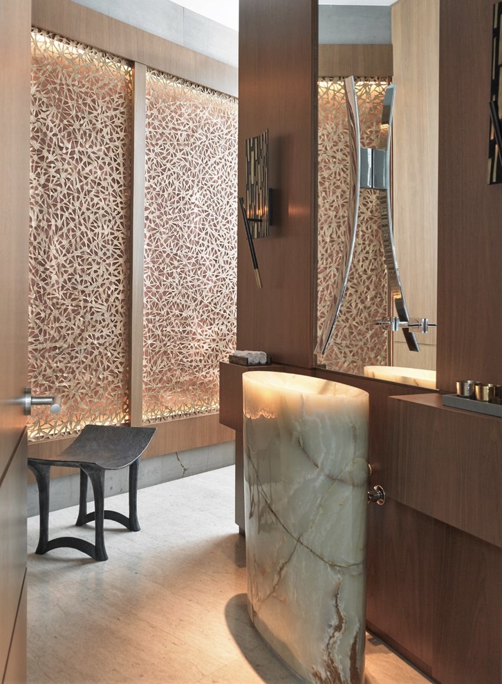 Inspiration for a contemporary beige floor powder room remodel in Other with dark wood cabinets and a pedestal sink