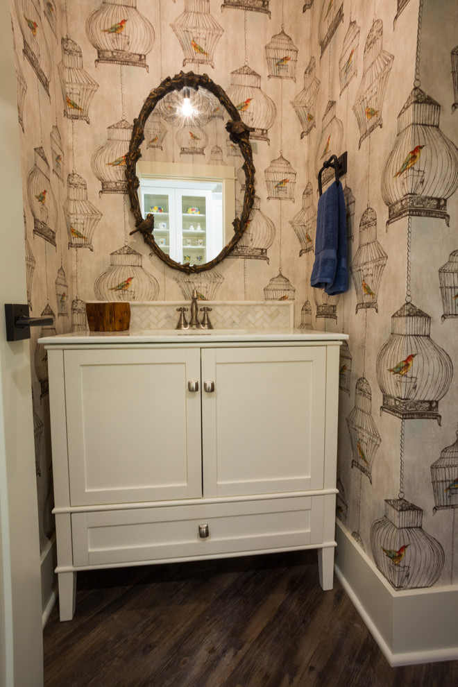 Powder room - mid-sized craftsman white tile and ceramic tile vinyl floor powder room idea in Austin with a drop-in sink, furniture-like cabinets, white cabinets, quartz countertops, a two-piece toilet and multicolored walls