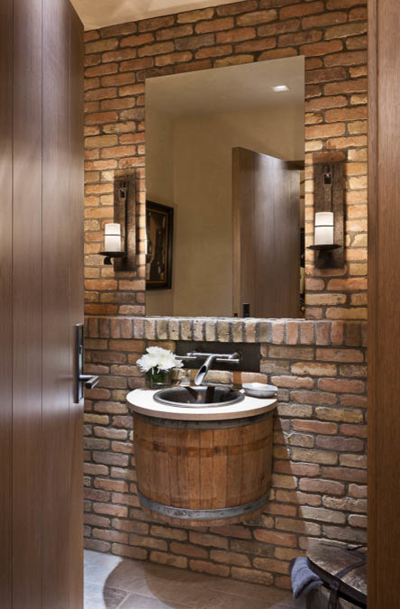 Small mountain style ceramic tile and gray floor powder room photo in Other with multicolored walls, an integrated sink and limestone countertops