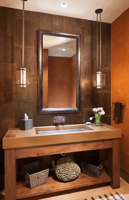 Example of a mid-sized arts and crafts brown tile light wood floor and brown floor powder room design in Other with open cabinets, medium tone wood cabinets, orange walls, an integrated sink and concrete countertops