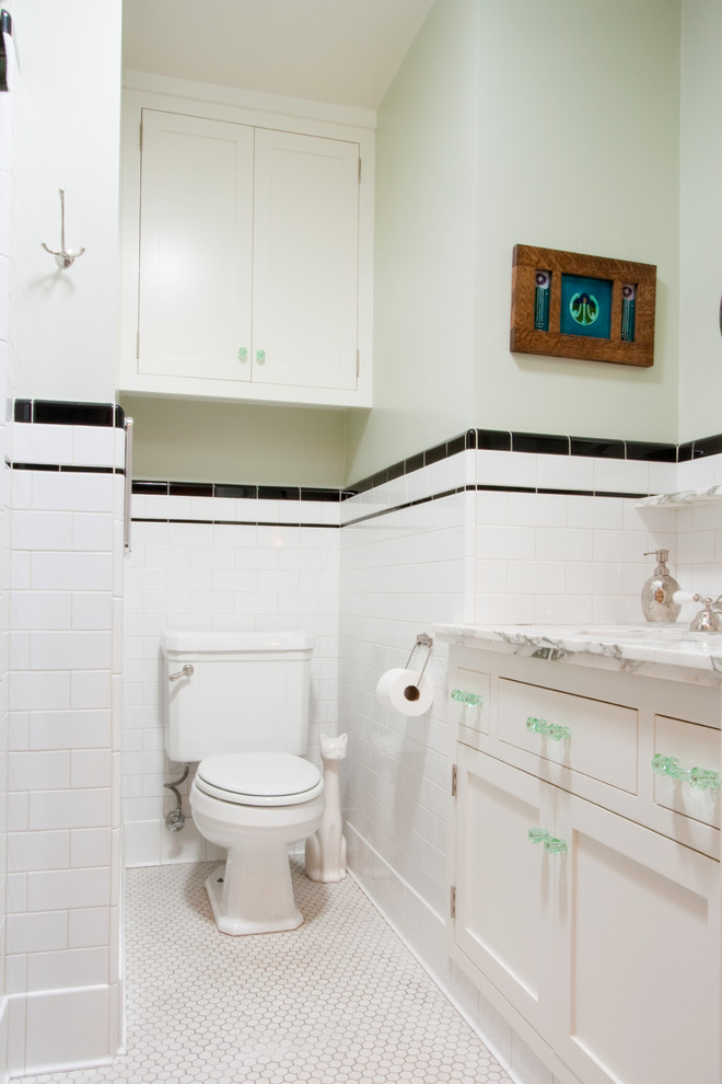 Example of a small arts and crafts white tile and subway tile ceramic tile powder room design in Los Angeles with recessed-panel cabinets, white cabinets, a one-piece toilet, white walls, an undermount sink and marble countertops