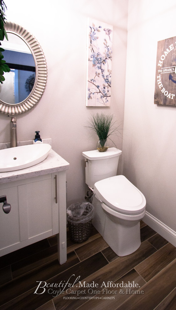 Example of a small trendy ceramic tile and brown floor powder room design in Other with furniture-like cabinets, white cabinets, a two-piece toilet, white walls, a vessel sink, quartz countertops and white countertops