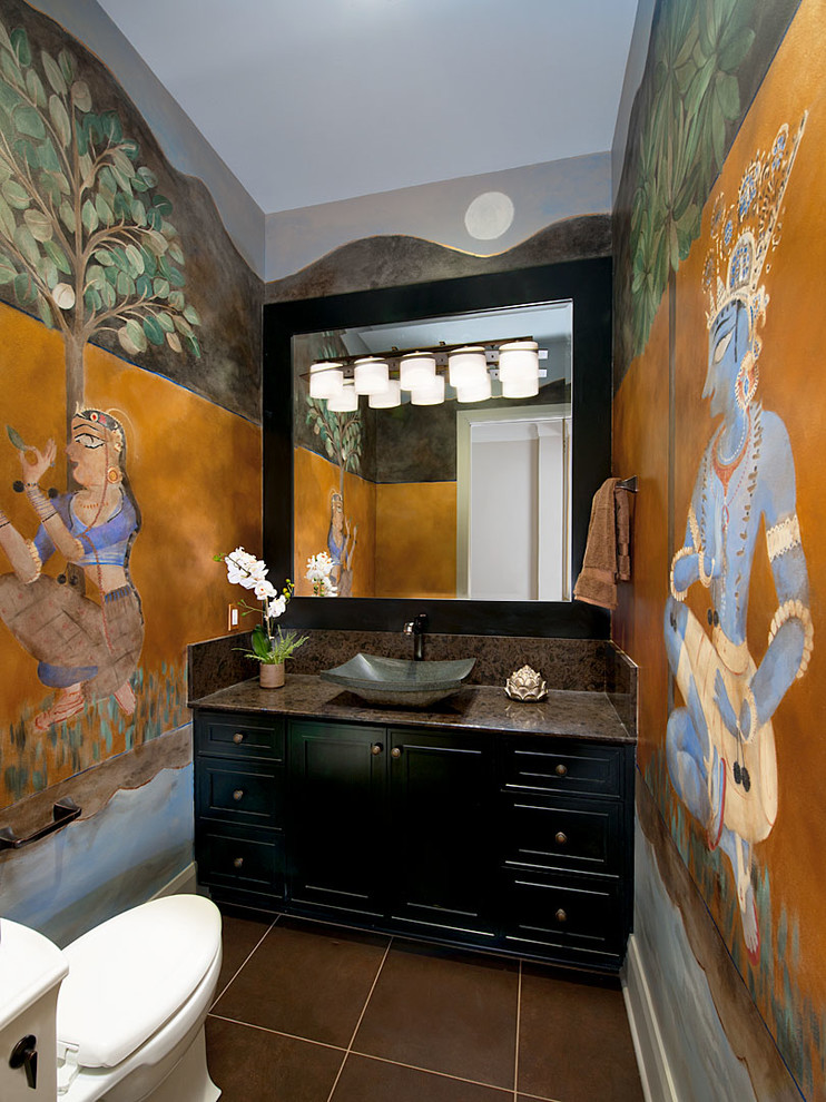 Inspiration for a mid-sized eclectic brown tile porcelain tile powder room remodel in Other with flat-panel cabinets, black cabinets, quartzite countertops, multicolored walls, a vessel sink and a one-piece toilet