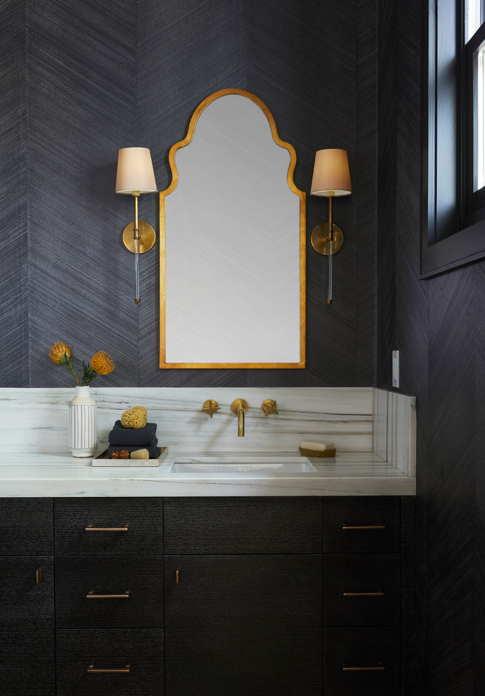 Inspiration for a small transitional light wood floor powder room remodel in San Francisco with flat-panel cabinets, dark wood cabinets, a one-piece toilet, black walls, an undermount sink, marble countertops and white countertops
