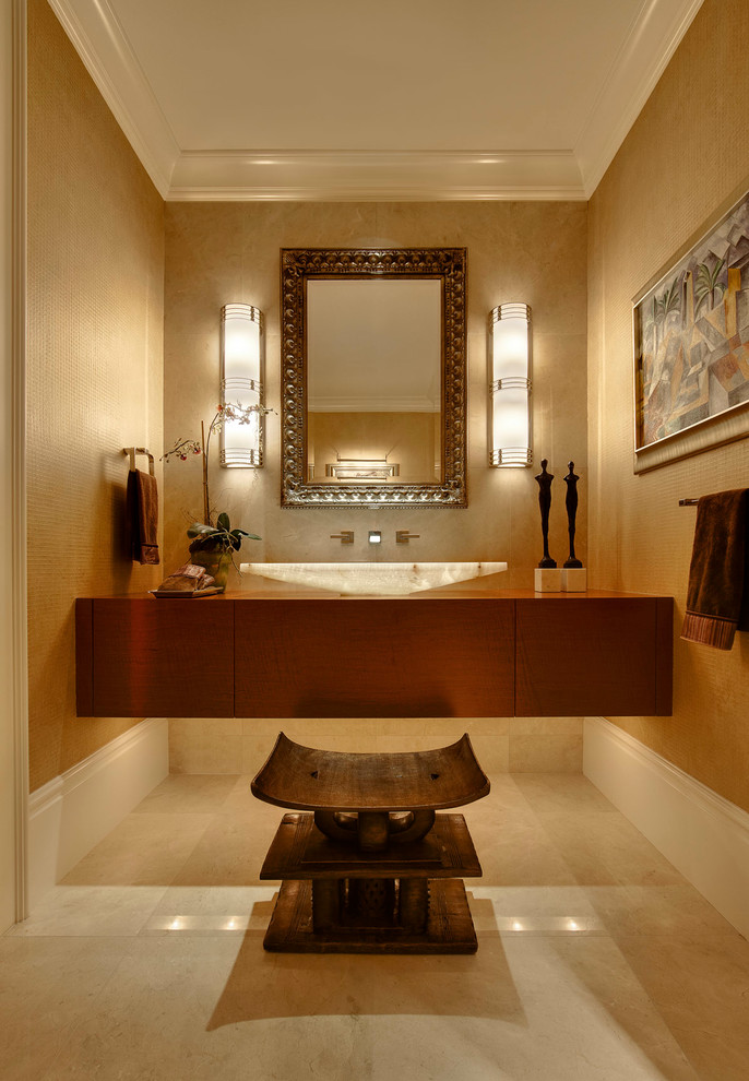 World-inspired cloakroom in Detroit with a vessel sink, beige tiles and beige walls.