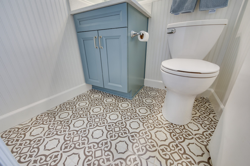 Photo of a medium sized traditional cloakroom in Portland with shaker cabinets, blue cabinets, a two-piece toilet, blue walls, porcelain flooring, a submerged sink, engineered stone worktops, black floors and white worktops.