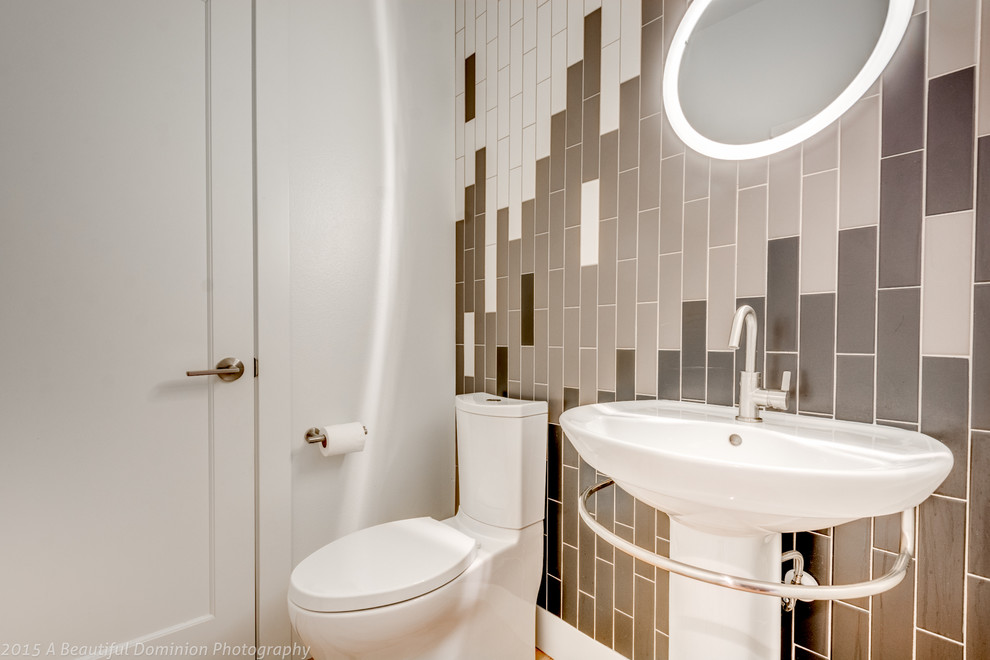 На фото: туалет среднего размера в современном стиле с унитазом-моноблоком, коричневой плиткой, белой плиткой, серой плиткой, белыми стенами и раковиной с пьедесталом с