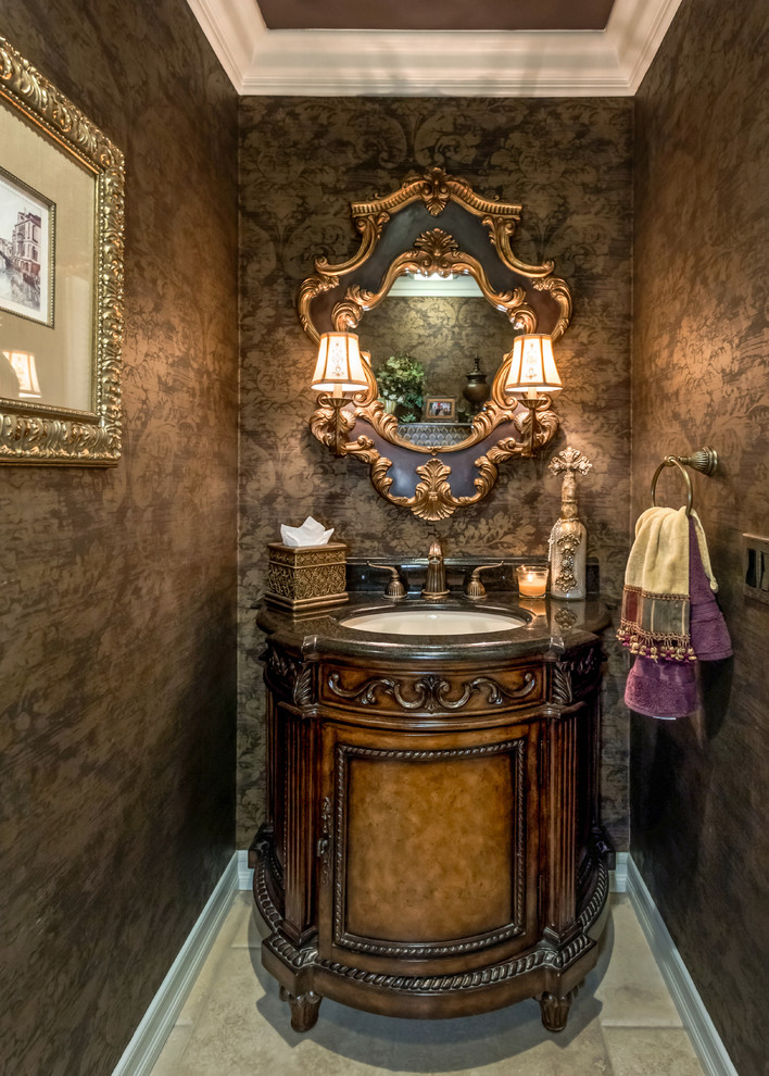Example of a small tuscan travertine floor powder room design in Orange County with furniture-like cabinets, dark wood cabinets, brown walls and an undermount sink