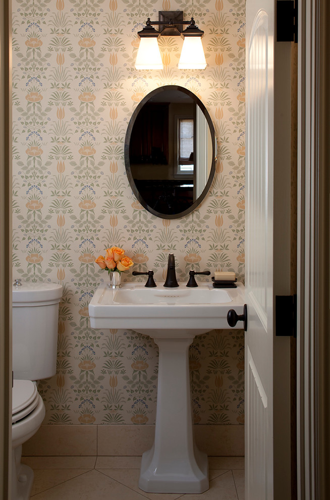 Inspiration for a small classic cloakroom in San Francisco with a pedestal sink, a two-piece toilet and limestone flooring.