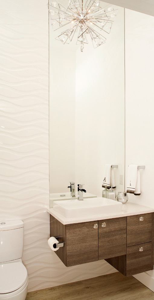 Cette photo montre un WC et toilettes moderne en bois brun avec une vasque, un placard à porte plane, un plan de toilette en quartz modifié, WC séparés, un carrelage blanc, des carreaux de porcelaine, un mur blanc, parquet clair et un plan de toilette blanc.