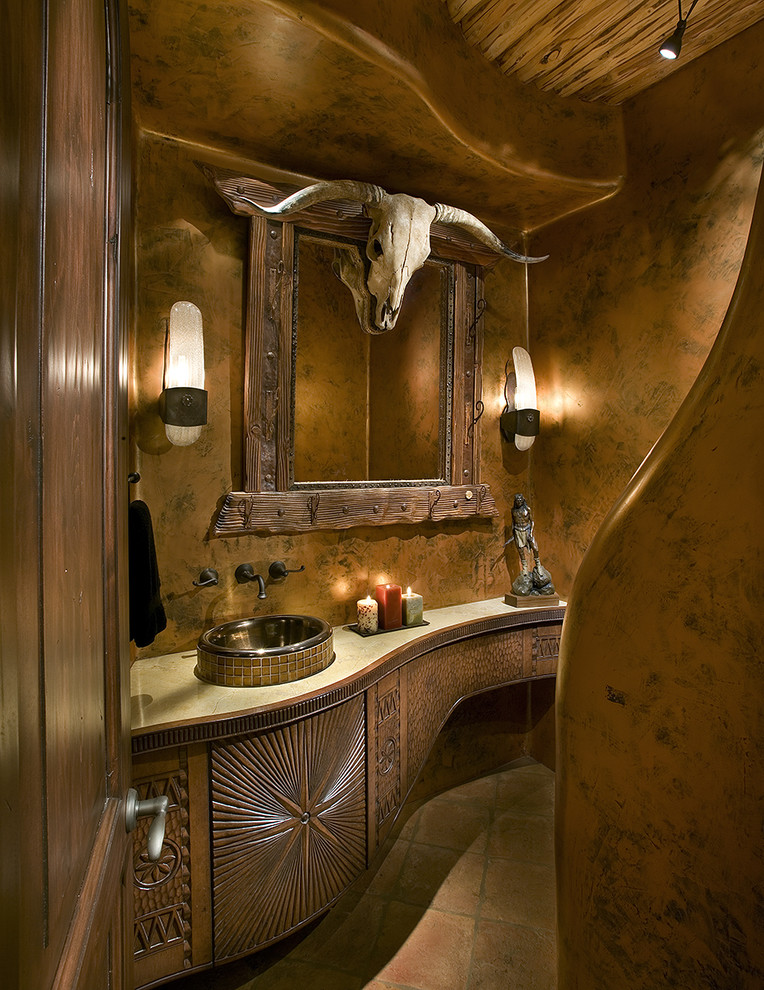 Example of a southwest powder room design in Phoenix with a vessel sink
