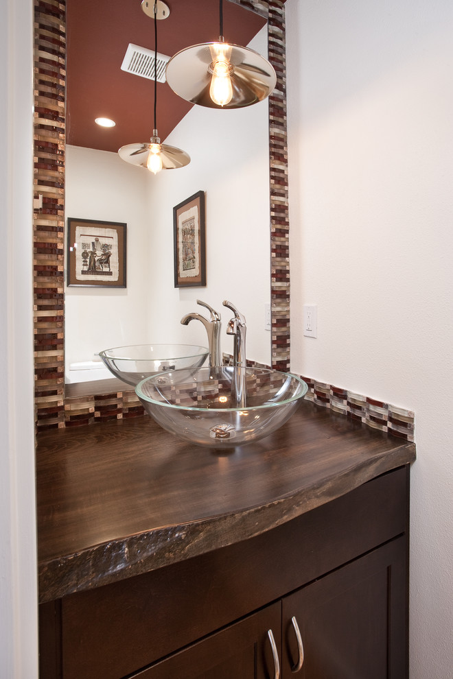 This is an example of a small bohemian cloakroom in Seattle with a vessel sink, shaker cabinets, dark wood cabinets, wooden worktops, multi-coloured tiles, white walls and brown worktops.