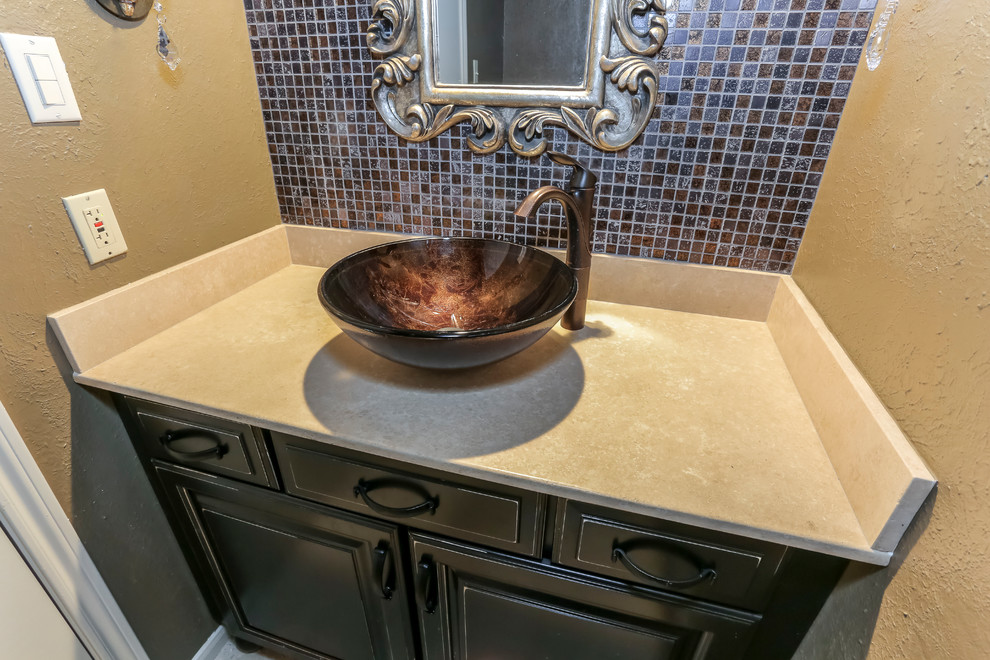 Design ideas for a cloakroom in Houston with raised-panel cabinets, brown cabinets, multi-coloured tiles, mosaic tiles, yellow walls, porcelain flooring and a vessel sink.