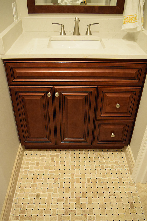 Design ideas for a small classic cloakroom in DC Metro with raised-panel cabinets, dark wood cabinets, grey walls, mosaic tile flooring, a submerged sink, engineered stone worktops and beige floors.