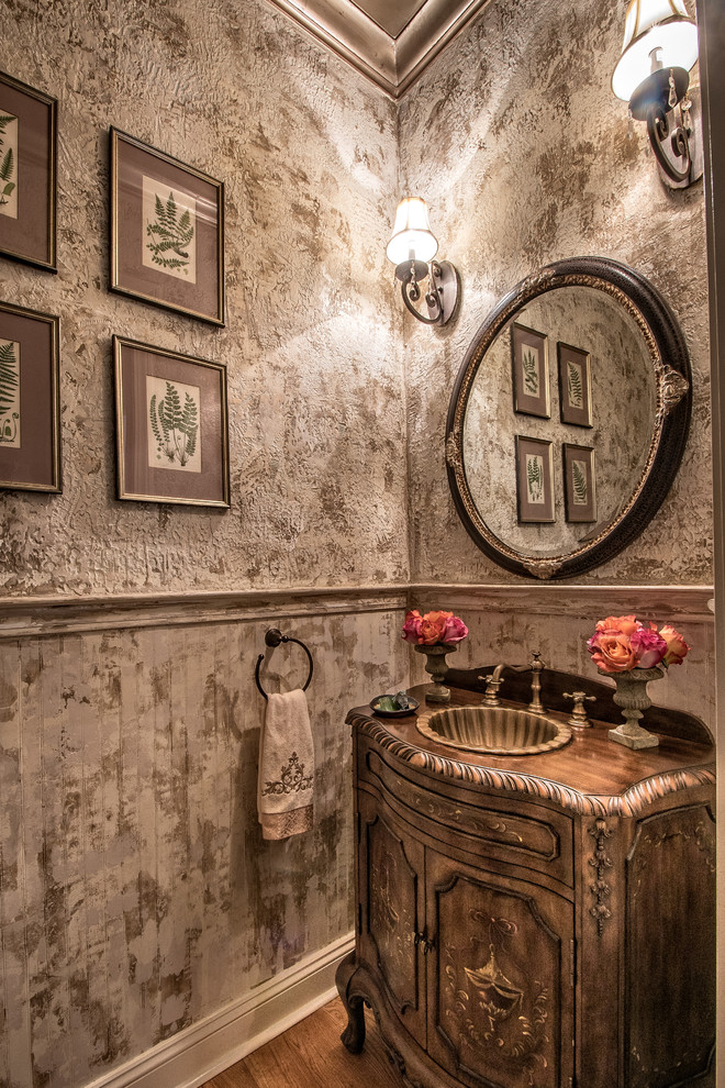 Idee per un bagno di servizio chic con lavabo da incasso, consolle stile comò, ante marroni, pareti grigie e top marrone