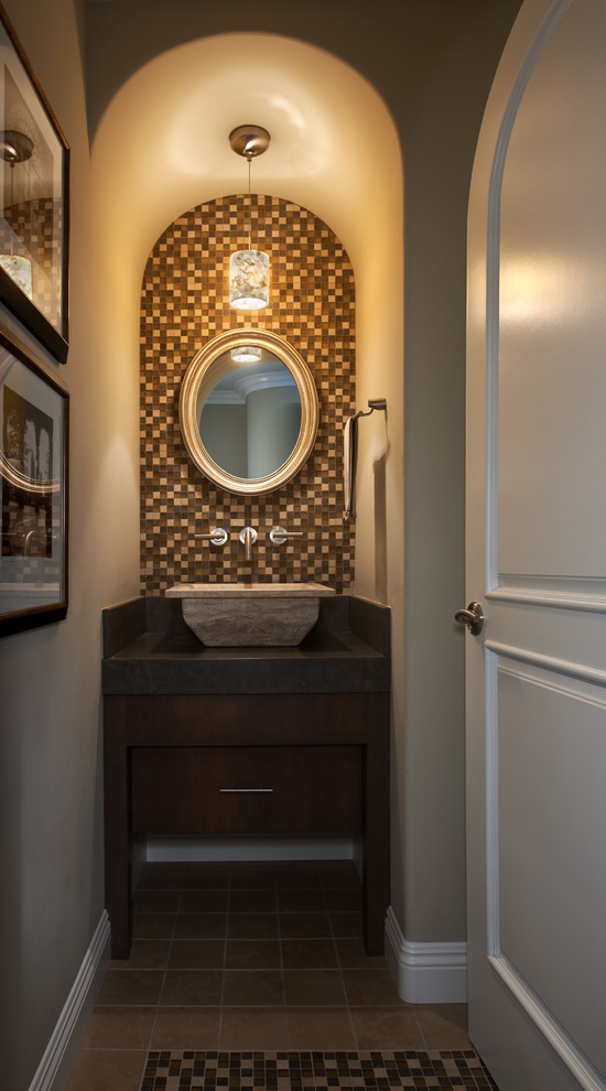 Design ideas for a small classic cloakroom in Orange County with flat-panel cabinets, dark wood cabinets, multi-coloured tiles, beige walls, ceramic flooring, a vessel sink, a one-piece toilet, solid surface worktops and mosaic tiles.