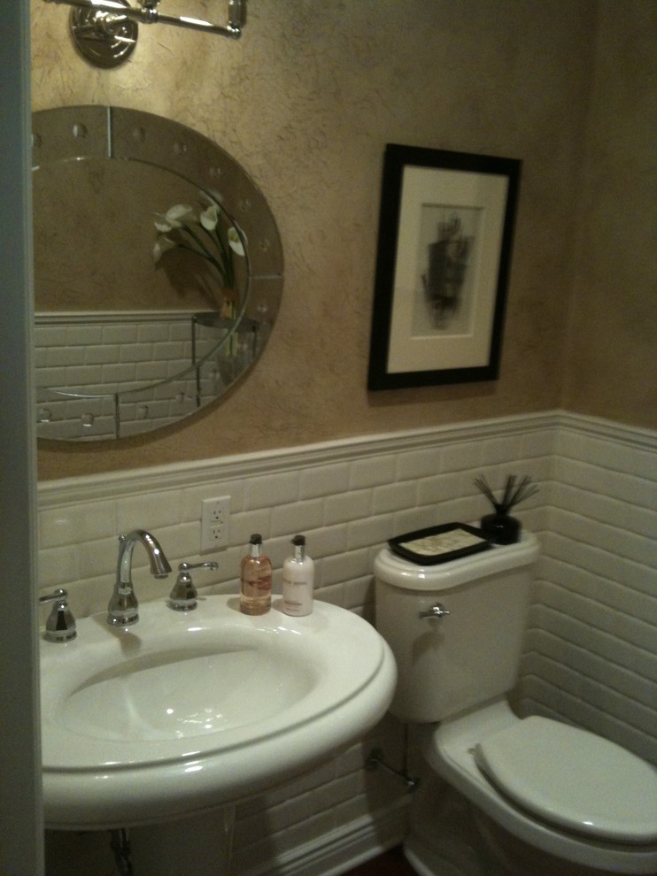 Example of a small classic powder room design in New York with a pedestal sink, a one-piece toilet and beige walls