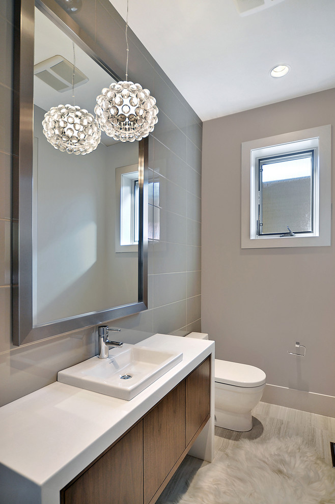 Design ideas for a contemporary cloakroom in Calgary with grey tiles, grey walls and a vessel sink.