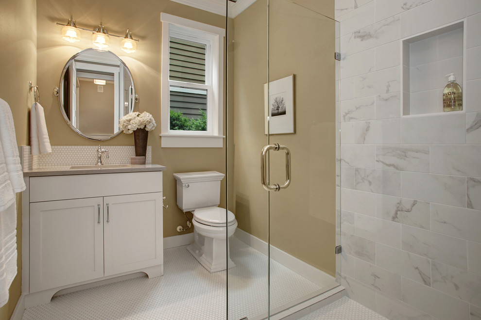 Example of an arts and crafts white tile and ceramic tile ceramic tile bathroom design in Seattle with shaker cabinets, white cabinets, a two-piece toilet, beige walls, an undermount sink and quartz countertops