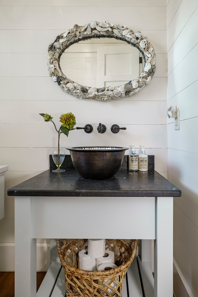 Photo of a small classic cloakroom in Charleston with freestanding cabinets, white cabinets, white walls, a vessel sink, medium hardwood flooring, soapstone worktops and black worktops.