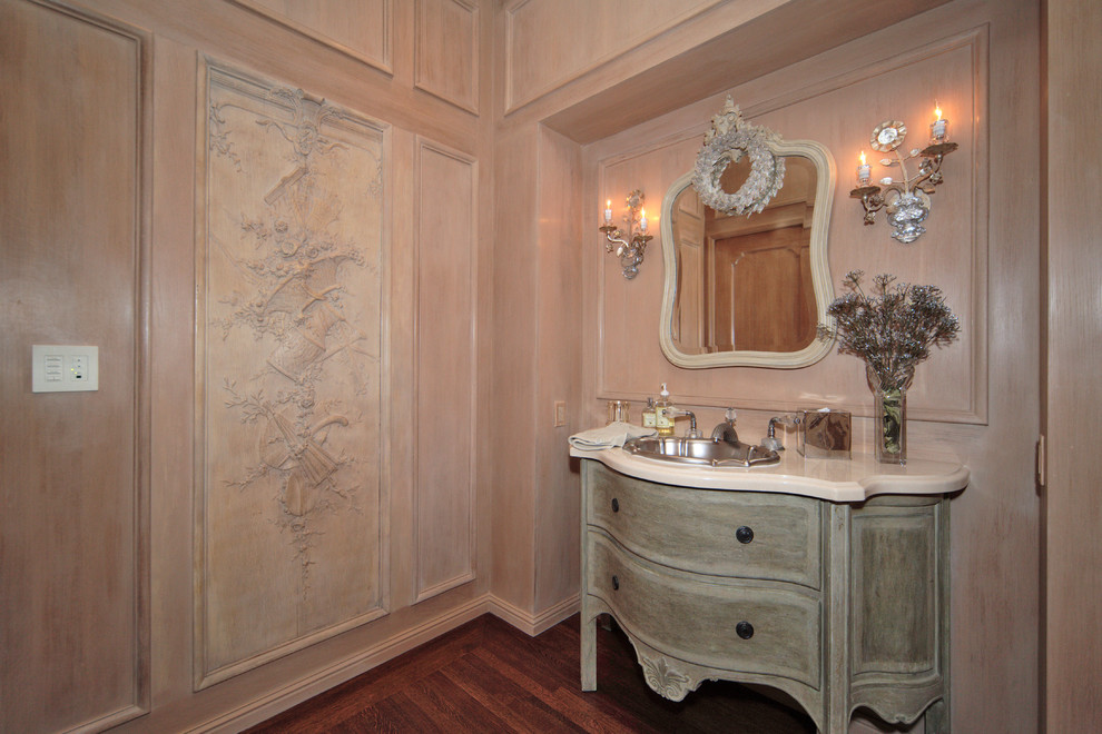 Photo of a medium sized traditional cloakroom in San Francisco with a built-in sink, freestanding cabinets, distressed cabinets, marble worktops, beige walls and dark hardwood flooring.