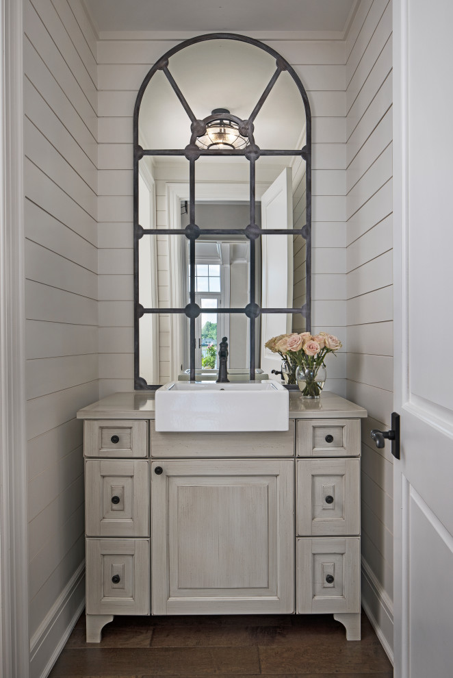 Inspiration for a small transitional brown floor powder room remodel in Detroit with furniture-like cabinets, beige cabinets, beige walls, a vessel sink and beige countertops