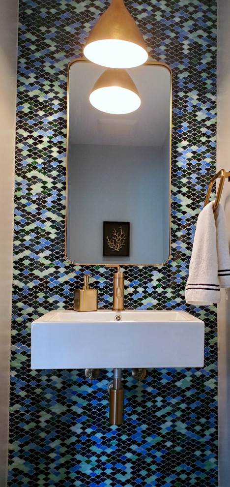 Inspiration for a small farmhouse cloakroom in Other with a one-piece toilet, multi-coloured tiles, glass tiles, blue walls, dark hardwood flooring, a wall-mounted sink and brown floors.