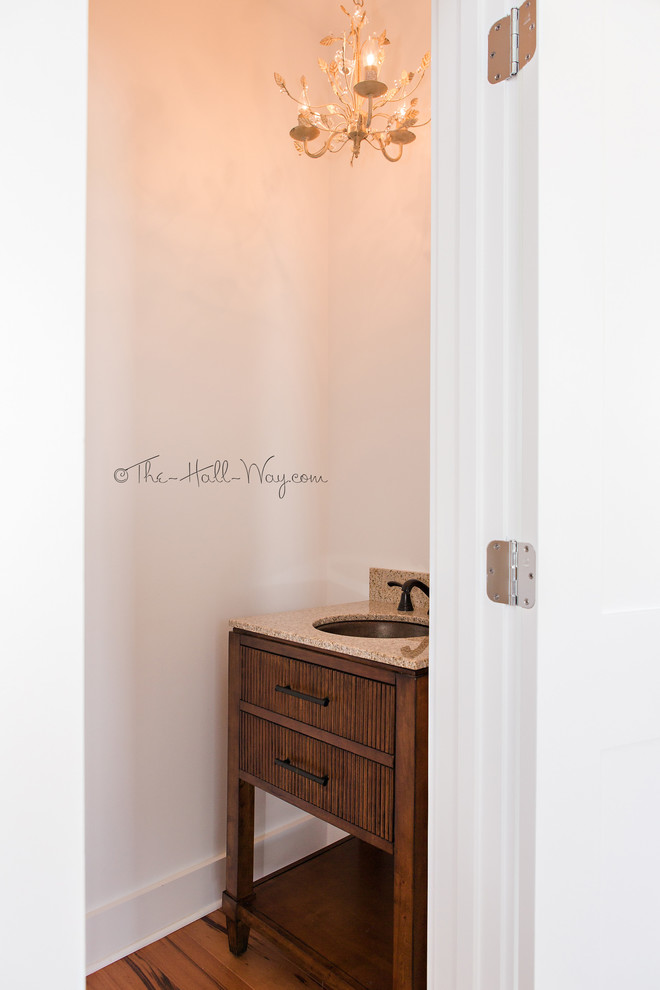 Cette photo montre un WC et toilettes bord de mer en bois brun de taille moyenne avec un placard en trompe-l'oeil, WC séparés, un mur blanc, un sol en bois brun, un lavabo encastré et un plan de toilette en granite.