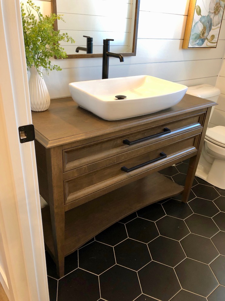 Photo of a medium sized rural cloakroom in Other with freestanding cabinets, medium wood cabinets, white walls, ceramic flooring, a vessel sink, wooden worktops, black floors and brown worktops.