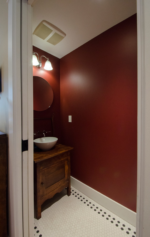 This is an example of a small classic cloakroom in Vancouver with a vessel sink, freestanding cabinets, wooden worktops, red walls and dark wood cabinets.