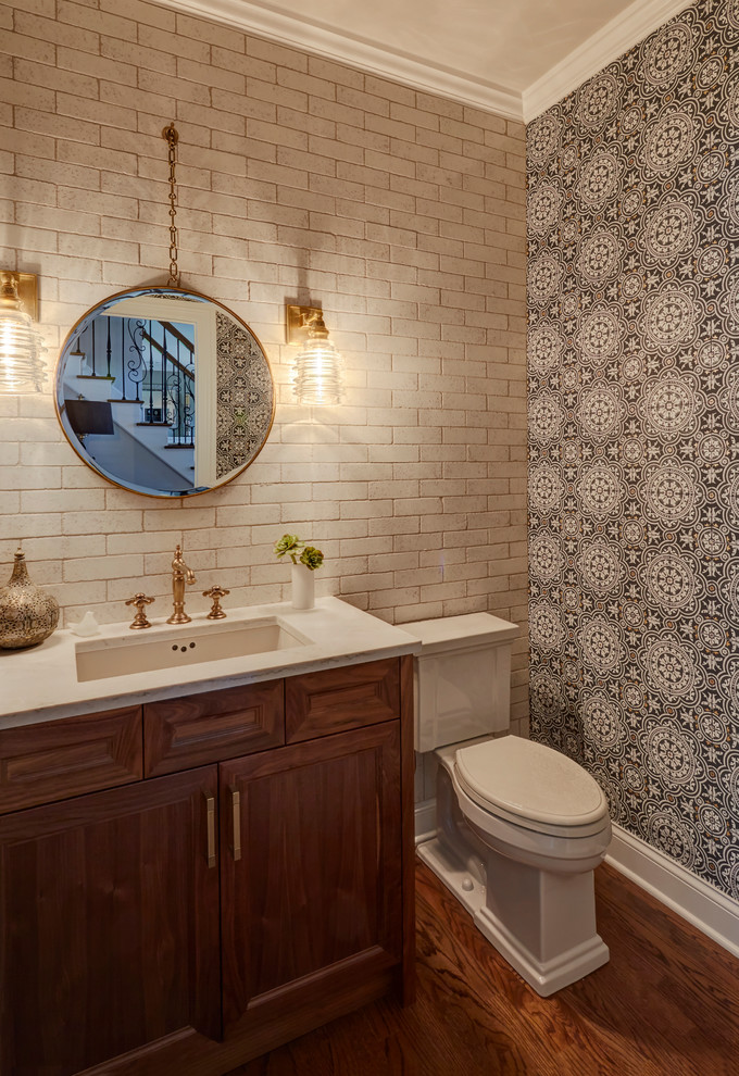 Example of an eclectic white tile and terra-cotta tile medium tone wood floor and brown floor powder room design in Chicago with recessed-panel cabinets, medium tone wood cabinets, a two-piece toilet, black walls, an undermount sink and quartzite countertops