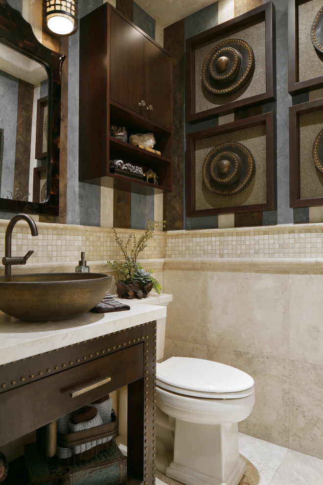 Photo of a small classic cloakroom in Orange County with a vessel sink, flat-panel cabinets, dark wood cabinets, limestone worktops, a two-piece toilet, beige tiles, travertine flooring and limestone tiles.