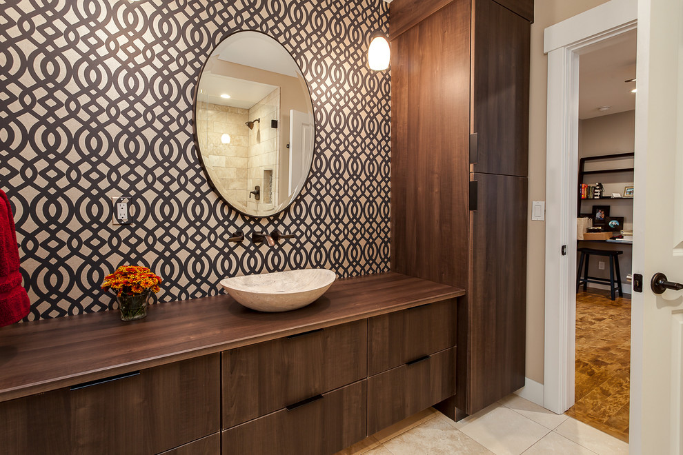 Mid-sized trendy powder room photo in Denver with flat-panel cabinets, medium tone wood cabinets, multicolored walls, a vessel sink and wood countertops