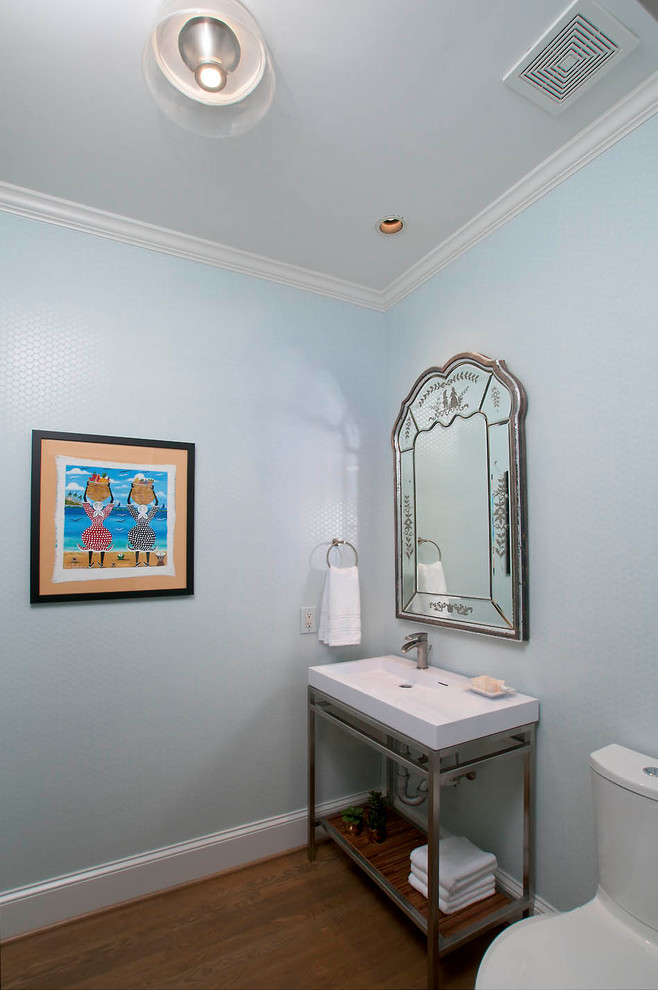 Photo of a medium sized traditional cloakroom in Atlanta with a one-piece toilet, blue walls, medium hardwood flooring, an integrated sink and brown floors.