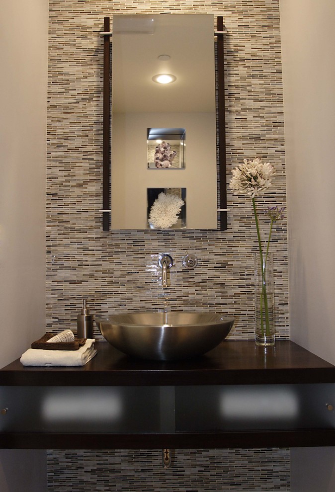Minimalist powder room photo in Los Angeles with a vessel sink and brown countertops