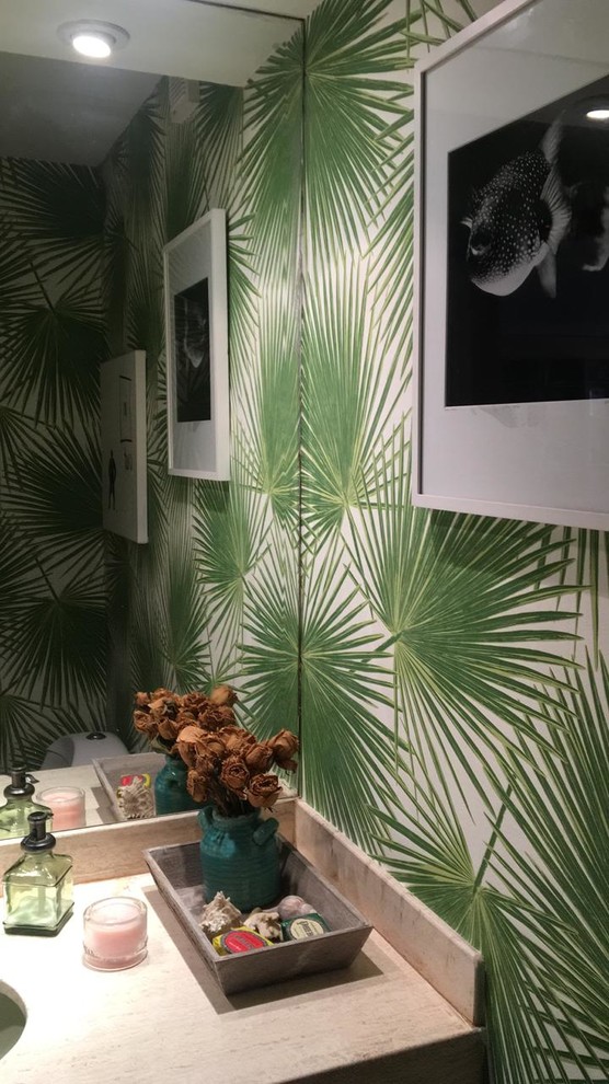 Inspiration for a small tropical powder room remodel in Miami with green walls