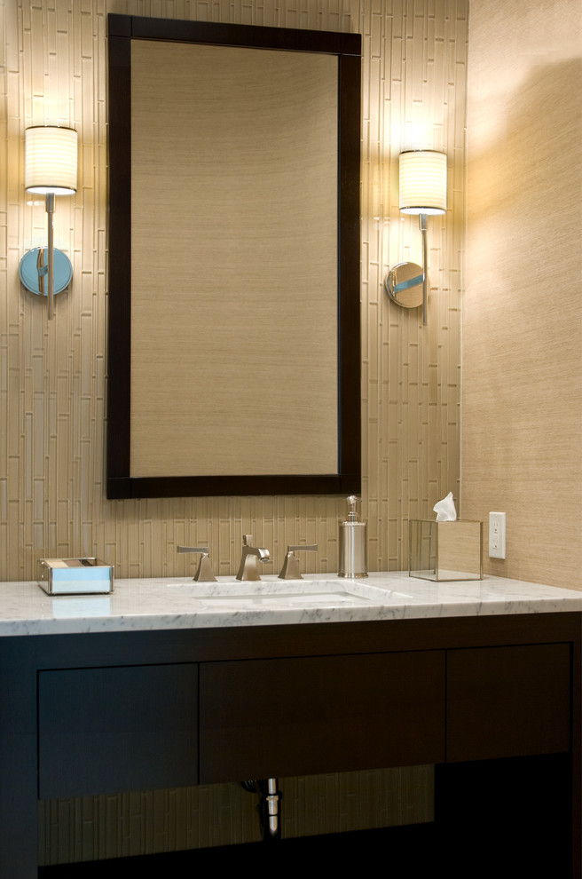 Example of a small transitional glass tile powder room design in New York with an undermount sink, flat-panel cabinets, dark wood cabinets, marble countertops, beige walls and white countertops