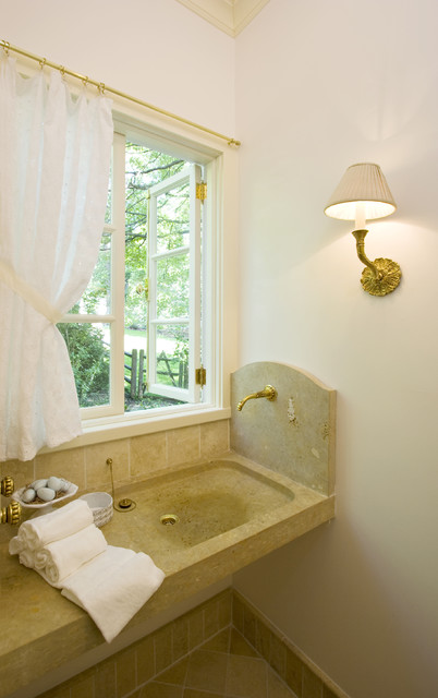 Powder Room with carved stone sink and wall mounted faucet ...