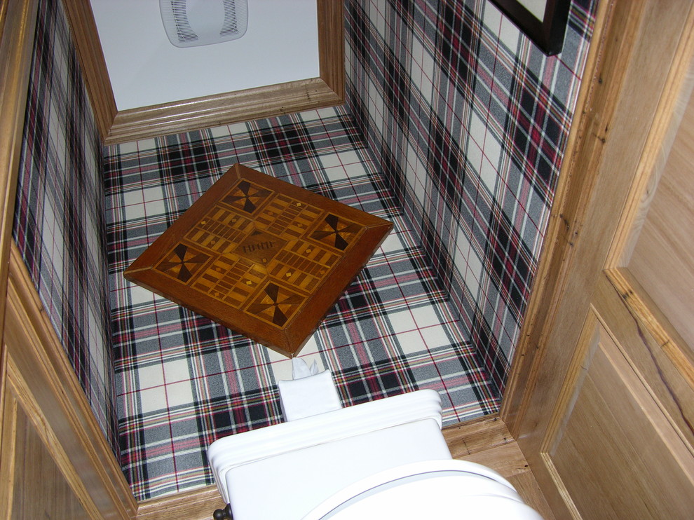 Example of a small classic medium tone wood floor powder room design in Austin with a one-piece toilet and multicolored walls