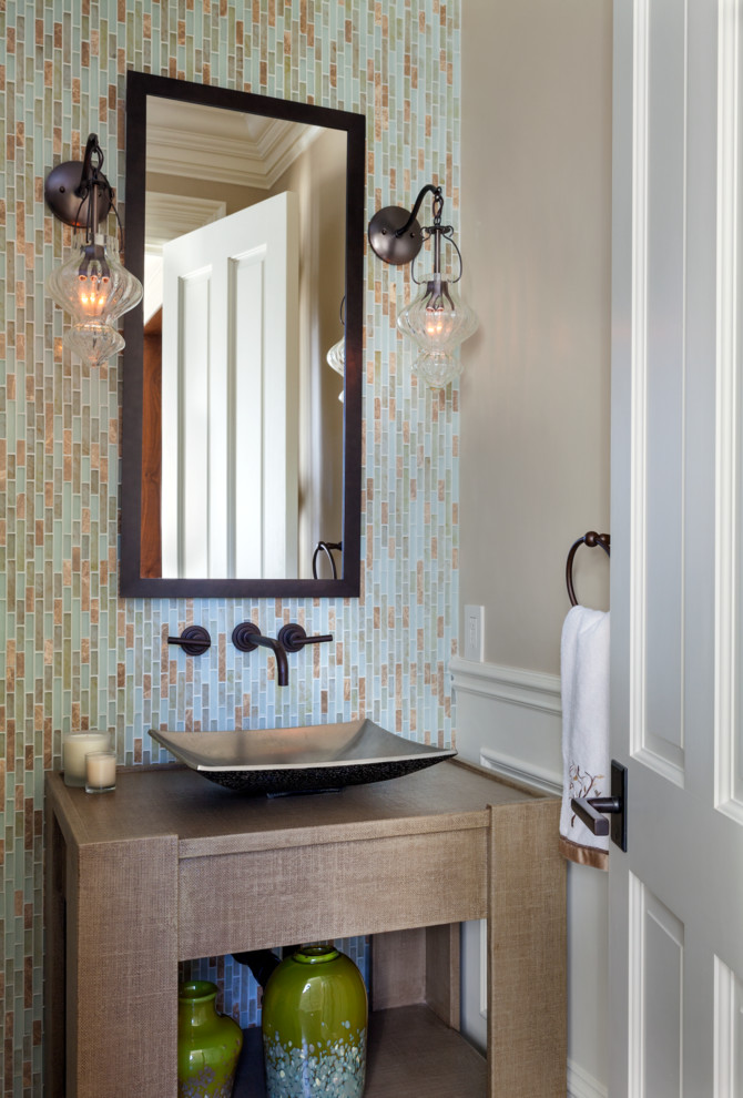 This is an example of a small traditional cloakroom in Boston with multi-coloured tiles, glass tiles, beige walls and a vessel sink.