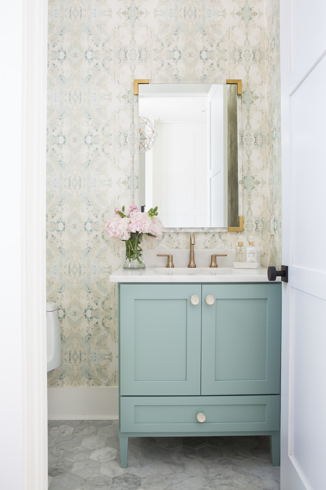 Transitional marble floor and gray floor powder room photo in Other with shaker cabinets, green cabinets, a one-piece toilet, an undermount sink, marble countertops, white countertops and multicolored walls