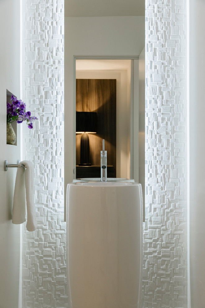 Photo of a small contemporary cloakroom in Los Angeles with a one-piece toilet, white tiles, porcelain tiles, white walls, porcelain flooring, a pedestal sink and white floors.