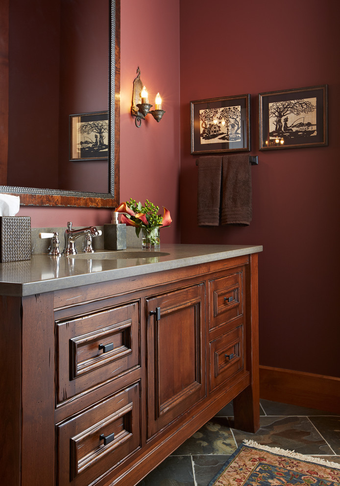 Inspiration for a mid-sized timeless slate floor and gray floor powder room remodel in Minneapolis with furniture-like cabinets, red walls, an undermount sink, medium tone wood cabinets and concrete countertops