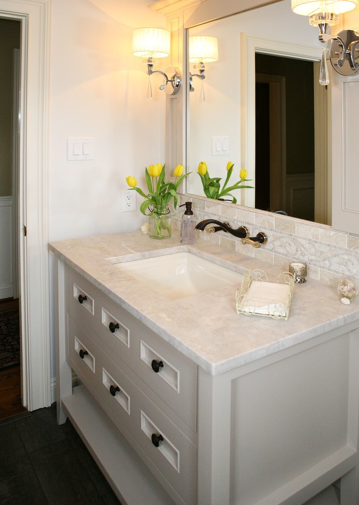 Photo of a medium sized traditional cloakroom in Philadelphia with freestanding cabinets, white cabinets, a two-piece toilet, beige walls, plywood flooring, a submerged sink, marble worktops and white worktops.