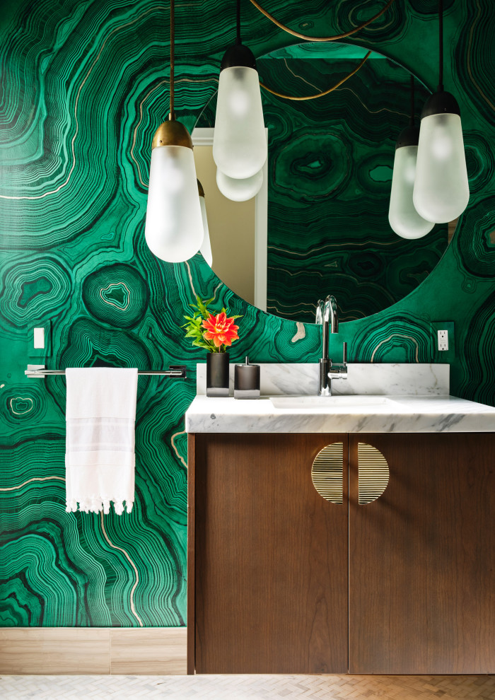 Inspiration for a contemporary gray floor and wallpaper powder room remodel in San Francisco with flat-panel cabinets, medium tone wood cabinets, multicolored walls, an undermount sink, marble countertops, gray countertops and a floating vanity